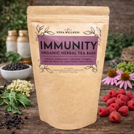 Keba Wellness immunity organic herbal tea bags packaging on a wooden surface with herbs and berries.